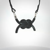 A gorgeous hand carved black jade reef knot pendant with sterling silver. Hand made in Black Jade with Sterling Silver and provided with adjustable cord.